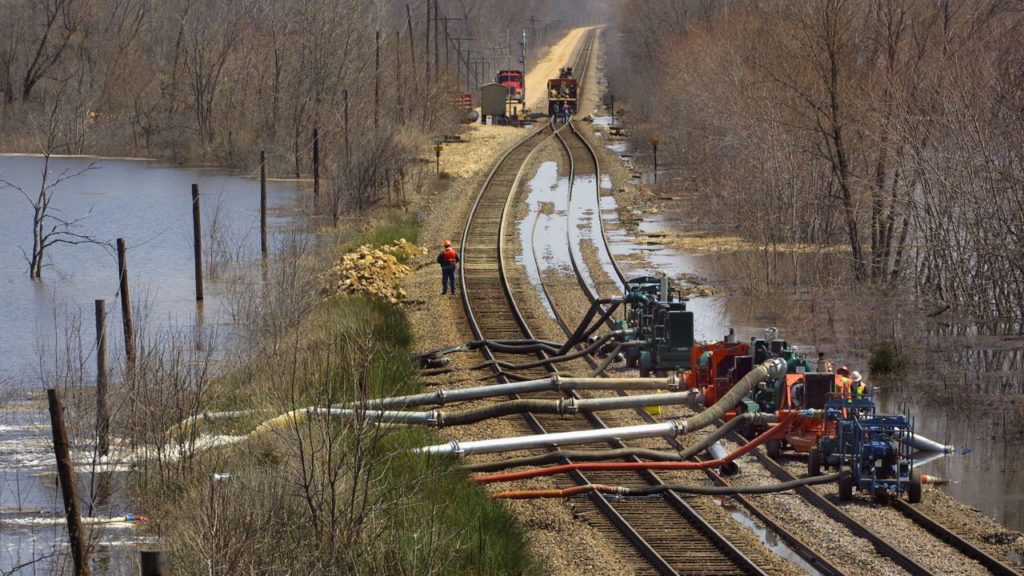 Pumps remove water from railroad tracks after flooding in Winona, Minnesota